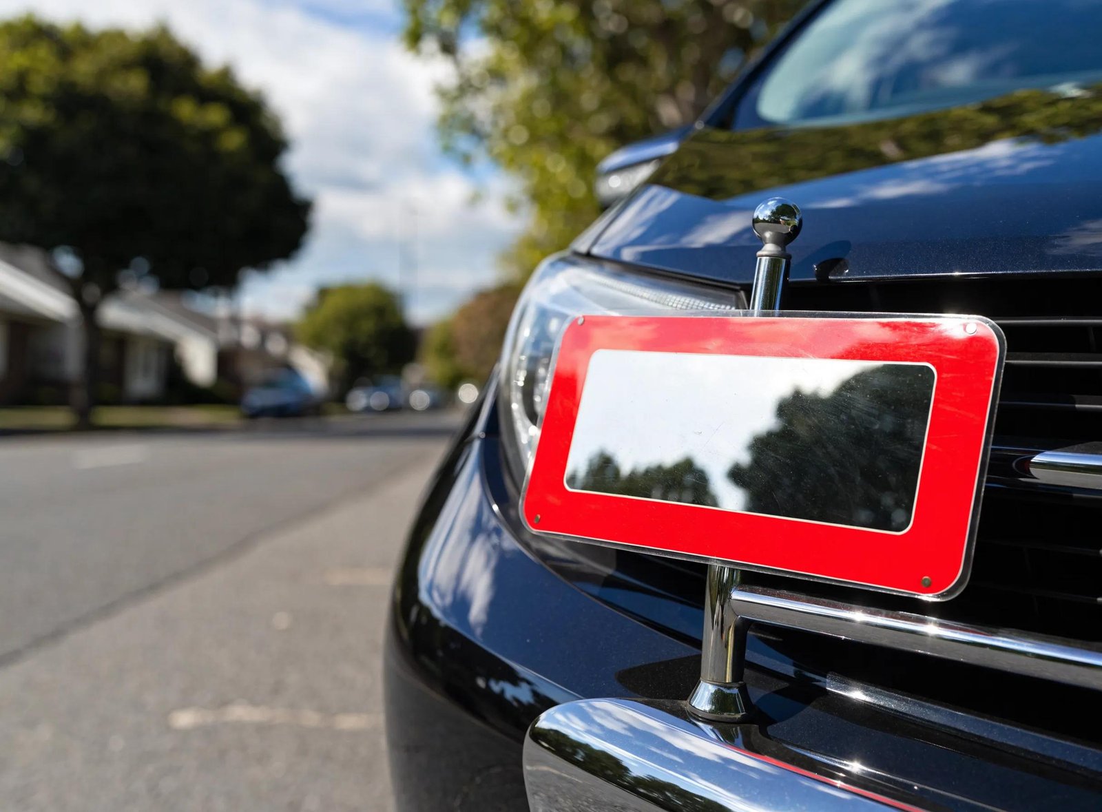 Close-up of L-plate on a car, highlighting VicRoads learner permit requirements.