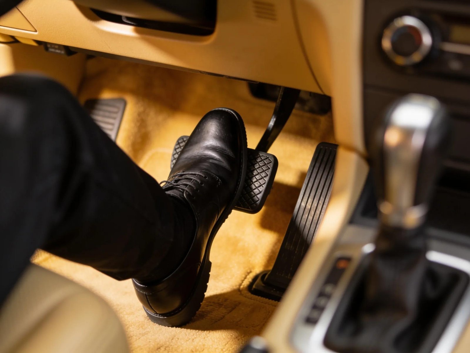 Close-up of a driver’s foot positioning on a clutch pedal showcasing manual driving techniques